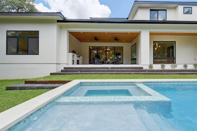 rear view of property with a swimming pool with hot tub and ceiling fan