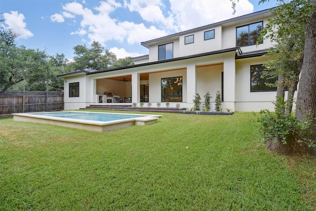 rear view of property featuring a lawn