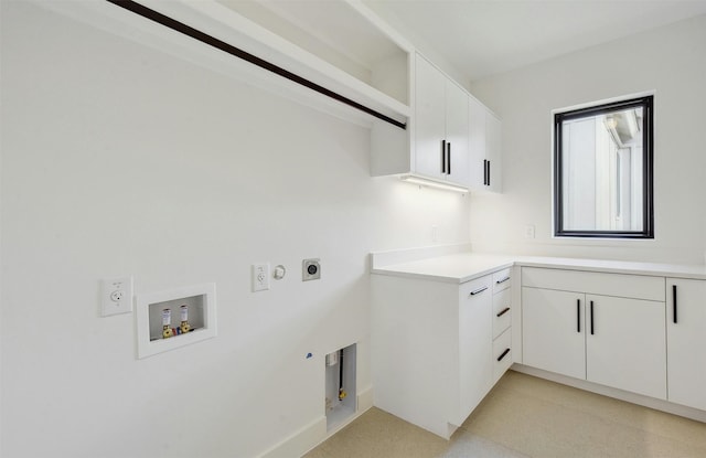 washroom with cabinets, hookup for a washing machine, hookup for a gas dryer, and electric dryer hookup