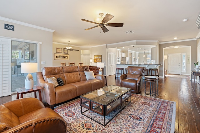 living room featuring hardwood / wood-style floors, ceiling fan, ornamental molding, and sink