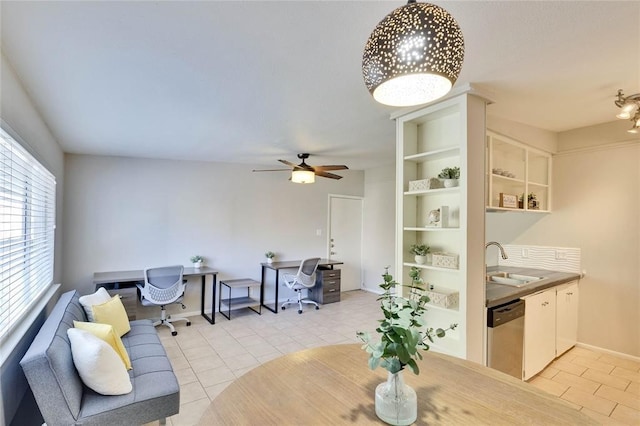 living room featuring built in shelves, ceiling fan, sink, and light tile patterned floors