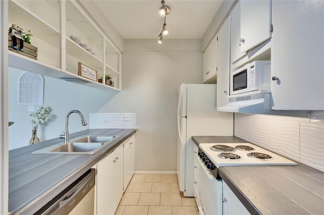 kitchen featuring white cabinets, light tile patterned floors, white appliances, and sink