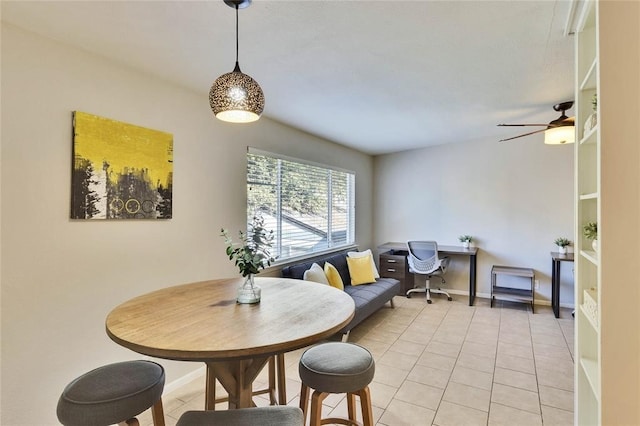 tiled dining space with ceiling fan