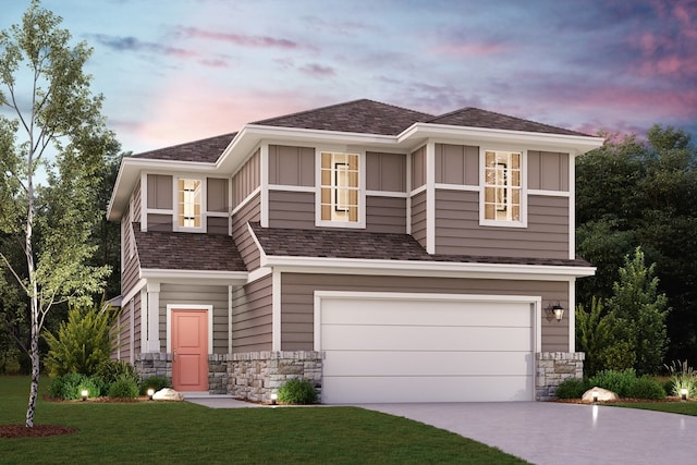 view of front of house with a garage and a lawn