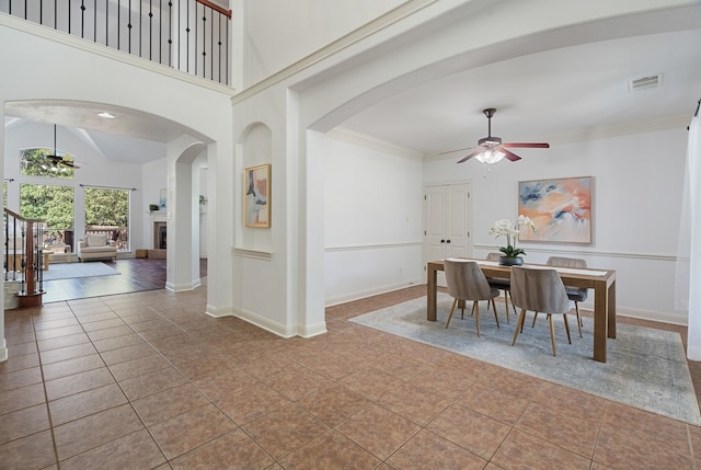 tiled dining space featuring ceiling fan and lofted ceiling