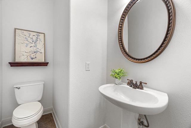 bathroom with tile patterned floors, toilet, and sink