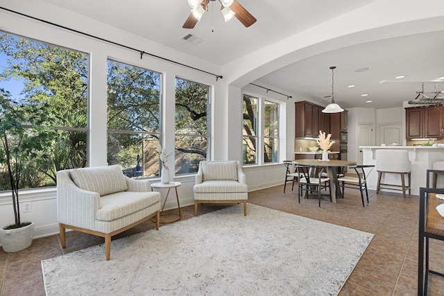 sunroom with plenty of natural light and ceiling fan