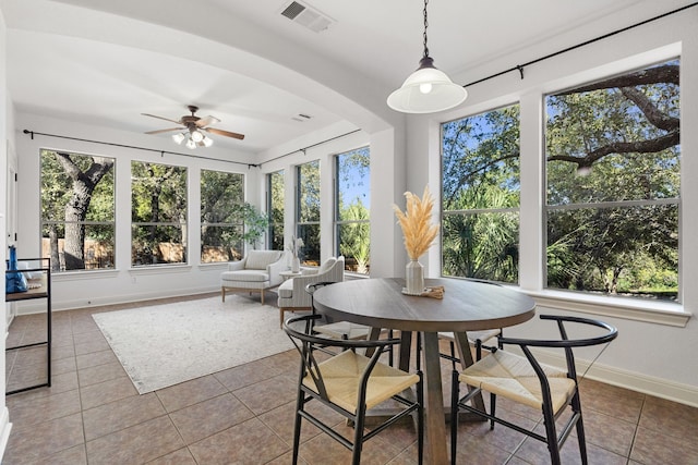 sunroom / solarium featuring ceiling fan