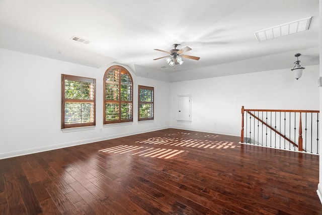 empty room with lofted ceiling, ceiling fan, and dark hardwood / wood-style floors