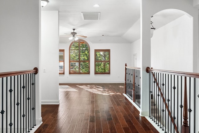 hall featuring dark wood-type flooring and lofted ceiling