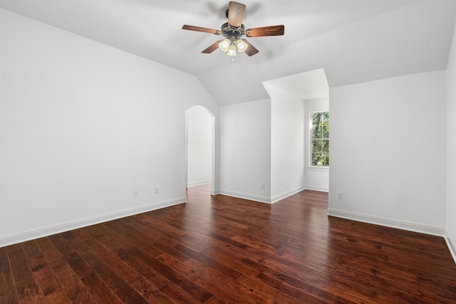 spare room featuring vaulted ceiling, ceiling fan, and dark hardwood / wood-style floors