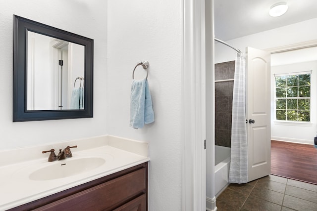 bathroom featuring tile patterned flooring, vanity, and shower / tub combo with curtain