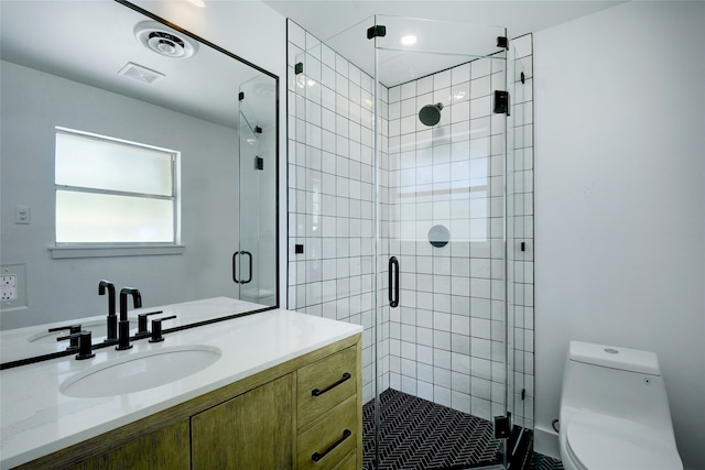 bathroom featuring walk in shower, vanity, and toilet