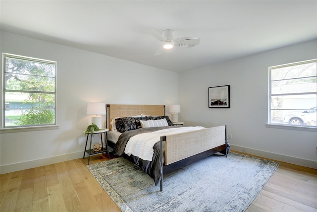 bedroom with ceiling fan and light hardwood / wood-style flooring