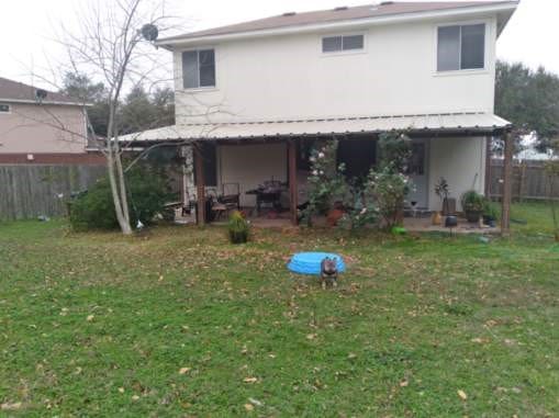 back of house with a lawn