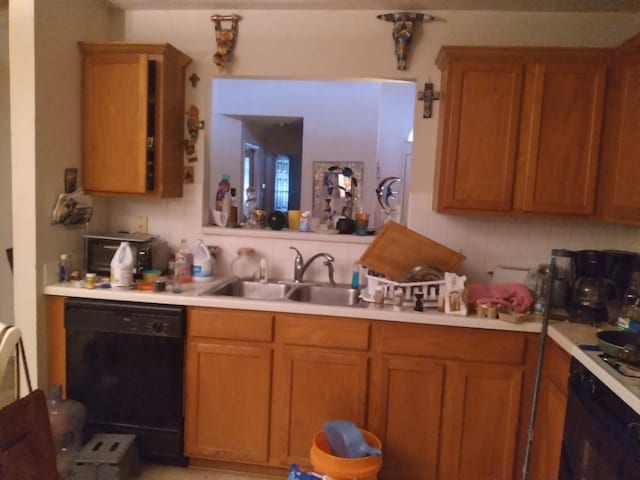 kitchen with wall oven, decorative backsplash, sink, and black dishwasher