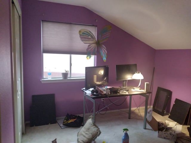 carpeted office space featuring vaulted ceiling