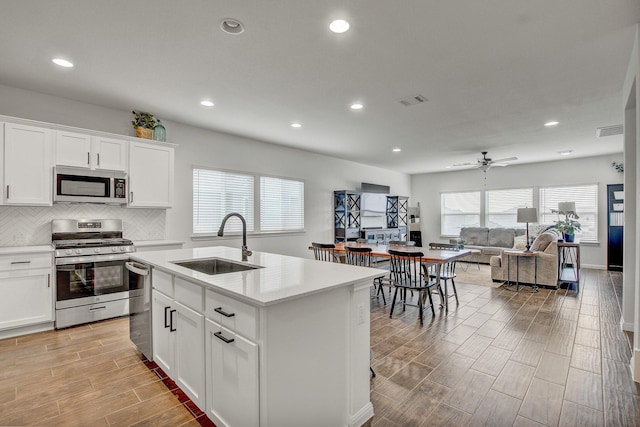 kitchen featuring white cabinetry, sink, and appliances with stainless steel finishes