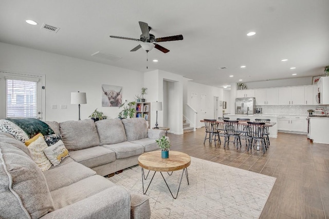 living room featuring ceiling fan and light wood-type flooring