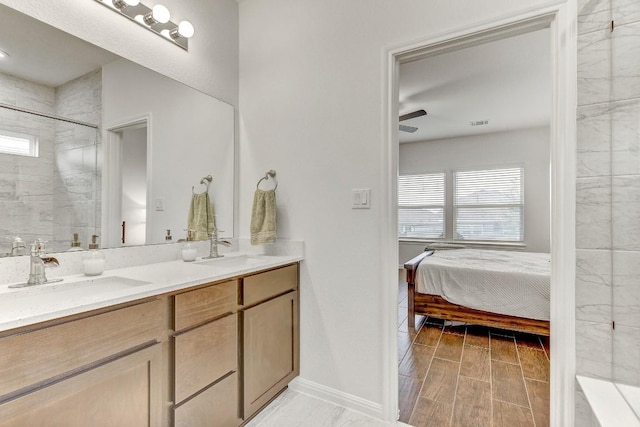 bathroom with vanity and a tile shower