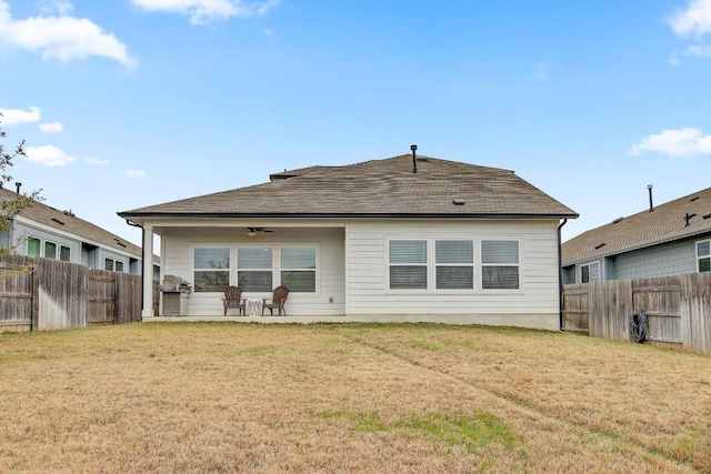 back of property with a lawn