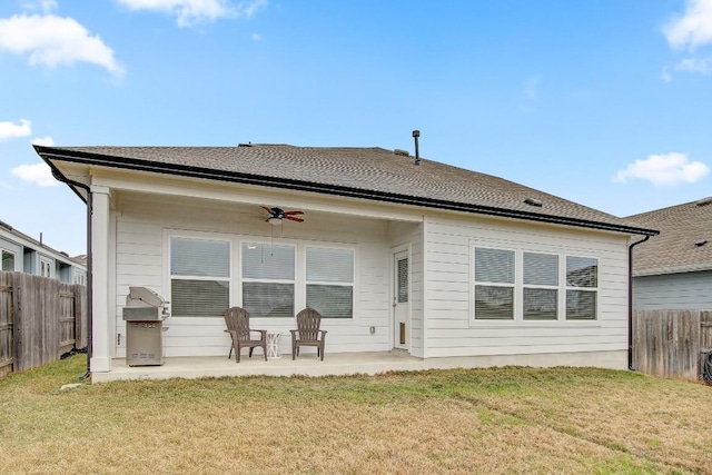 rear view of property with a lawn, a patio, and ceiling fan