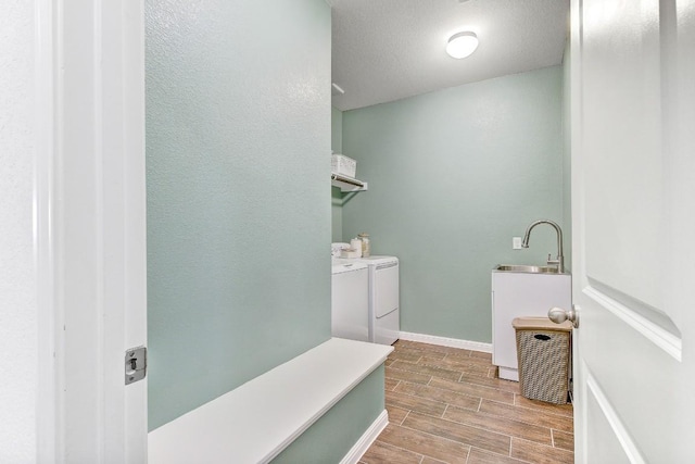 bathroom featuring sink and independent washer and dryer