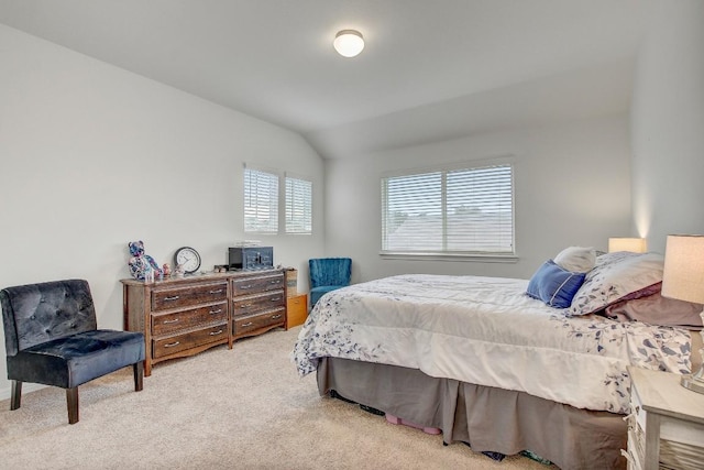 carpeted bedroom with lofted ceiling