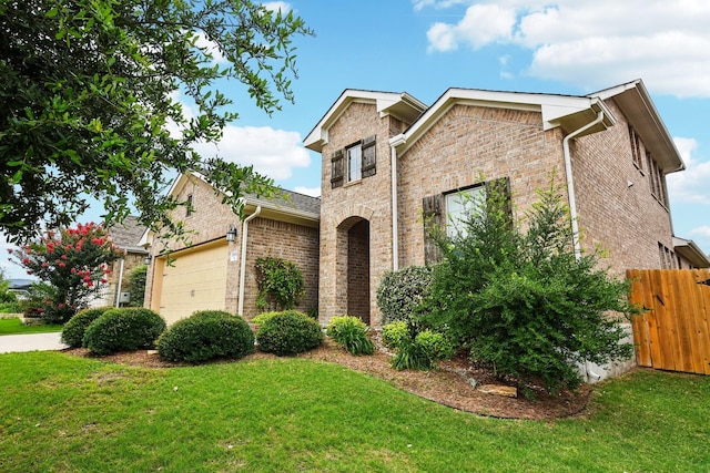 view of front of home featuring a garage and a front lawn