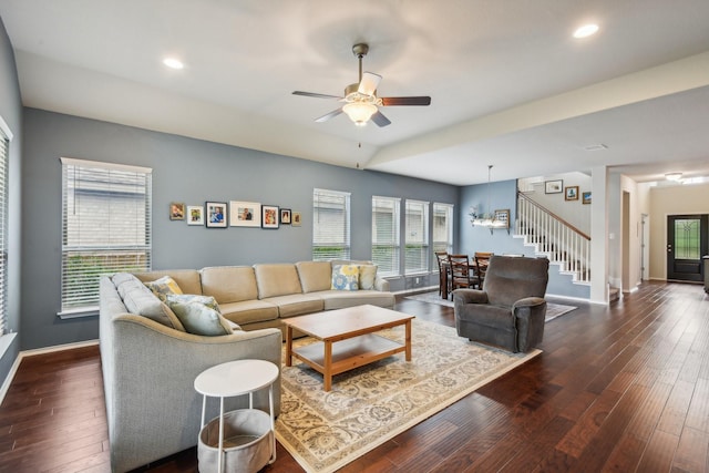 living room with ceiling fan and dark wood-type flooring