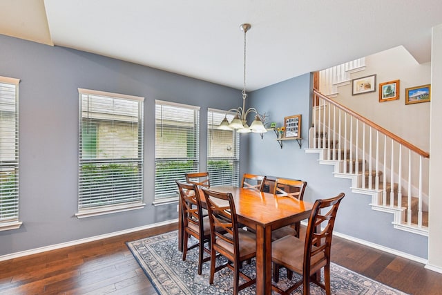 dining room featuring an inviting chandelier and dark wood-type flooring