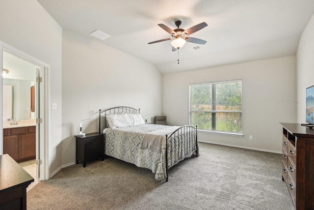 carpeted bedroom with vaulted ceiling, ensuite bath, and ceiling fan