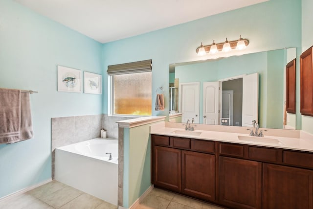 bathroom with tile patterned floors, vanity, and a tub