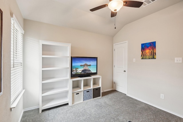 unfurnished living room featuring ceiling fan, carpet floors, and lofted ceiling