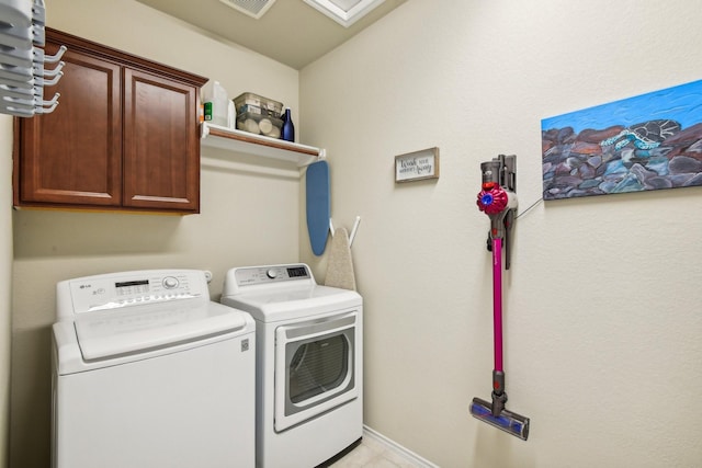 laundry area featuring cabinets and washing machine and clothes dryer