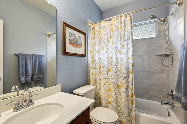 full bathroom with vanity, shower / tub combo, and toilet