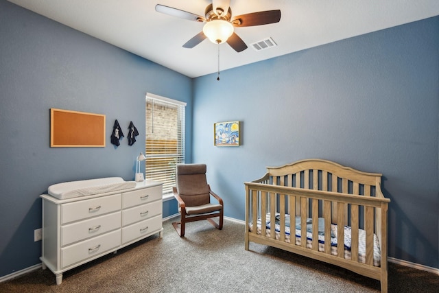 bedroom featuring ceiling fan, carpet, and a nursery area