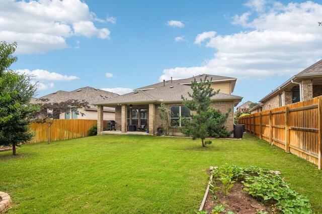 rear view of property featuring a yard