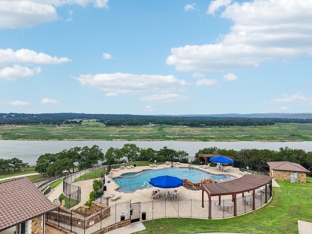 view of swimming pool with a water view