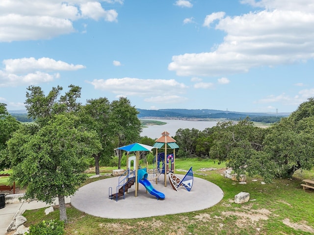 view of play area featuring a yard and a water view