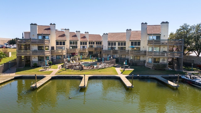 dock area with a yard and a water view