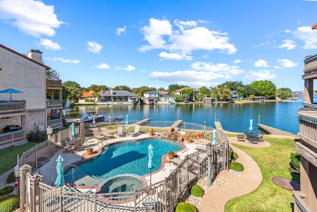 view of pool with an in ground hot tub, a water view, a patio, and a boat dock