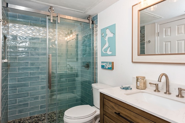 bathroom featuring vanity, toilet, and a shower with door