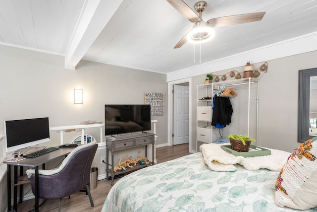 bedroom featuring ceiling fan, beamed ceiling, a closet, wood ceiling, and hardwood / wood-style flooring