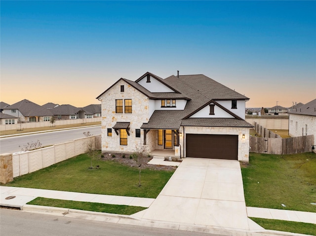 view of front of home featuring a yard and a garage