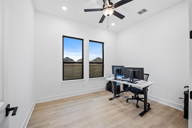 home office featuring light hardwood / wood-style floors and ceiling fan