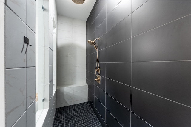 bathroom with a shower and tile walls