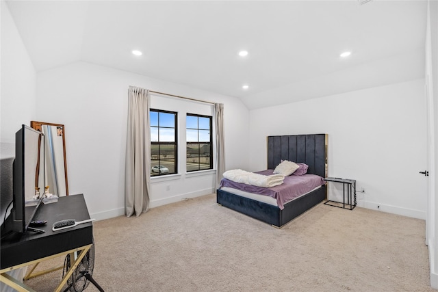 carpeted bedroom with lofted ceiling