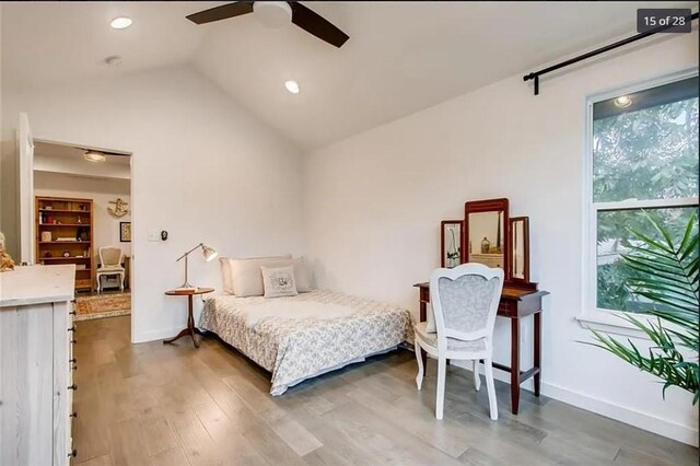 bedroom with ceiling fan, dark hardwood / wood-style floors, and lofted ceiling