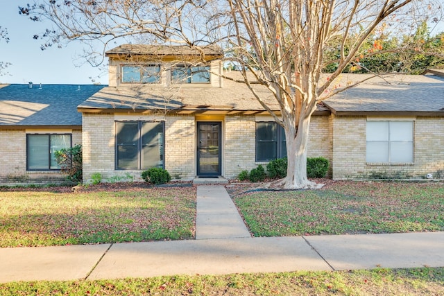 8233 Summer Side Dr Unit 172, Austin, TX 78759 - view of front of house featuring brick siding, a shingled roof, and a front yard